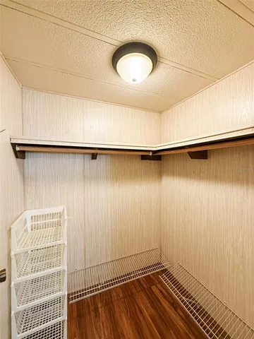 a view of a room with wooden floor