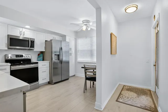 a kitchen with a refrigerator a stove top oven a sink and dishwasher
