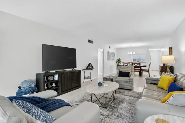 a bedroom with a bed and a flat tv screen on a dresser