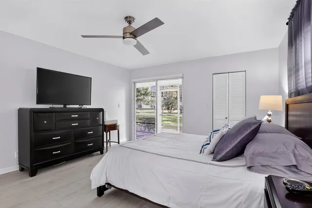 a bedroom with a large bed and a fireplace