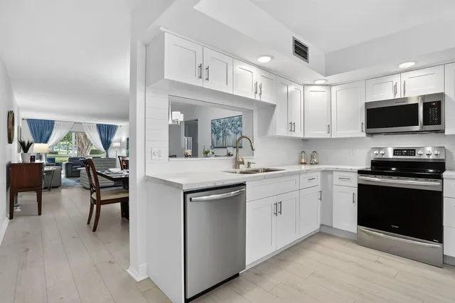 a kitchen with sink and cabinets