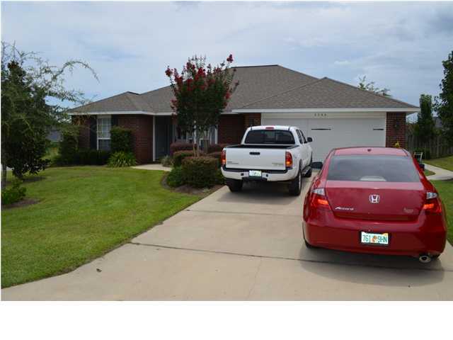 5200 Moore Loop Crestview, FL 32536 - Photo 1 of 29 a front view of a house with a garden