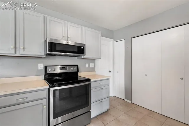 a kitchen with stainless steel appliances granite countertop a sink and a stove