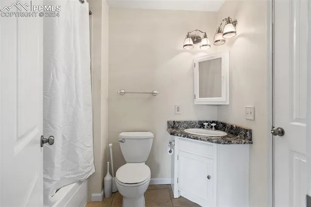 a view of a room with wooden floor and a window