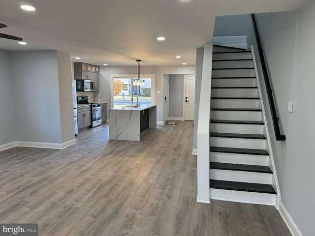 a view of kitchen with sink and wooden floor