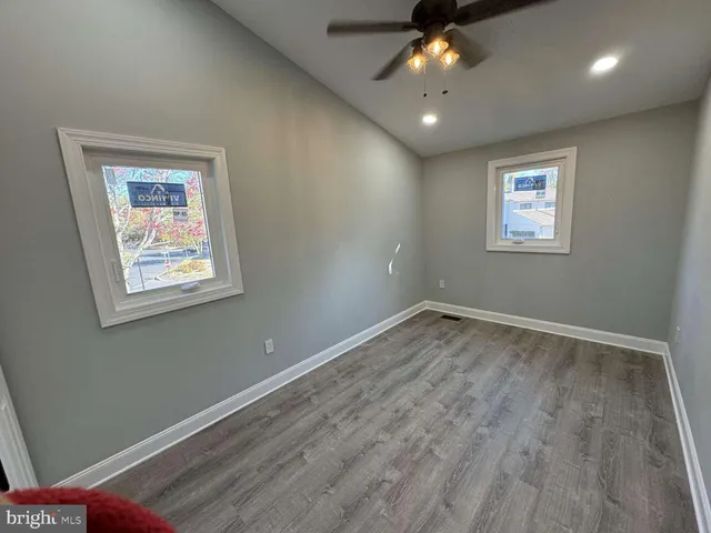 a view of an empty room and window ceiling fan