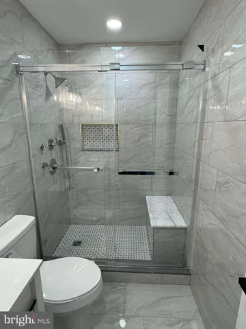 a bathroom with a toilet and a shower