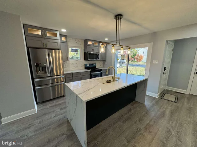 a kitchen with sink refrigerator and microwave