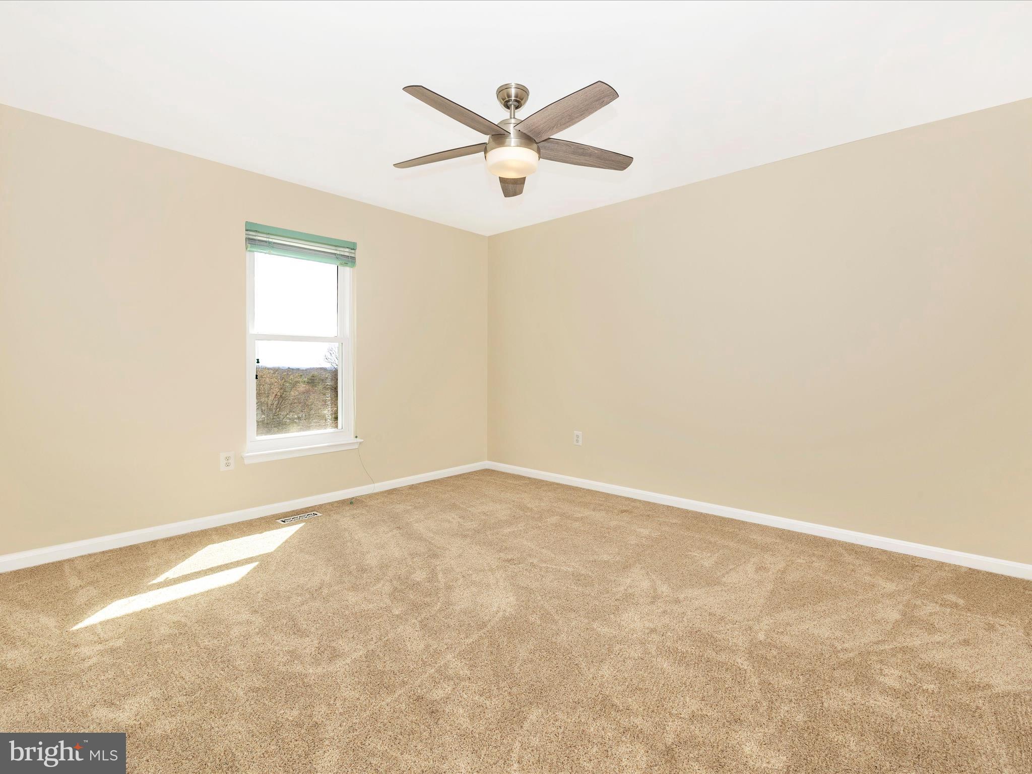 3831 Roundtree Road Jefferson, MD 21755 - Photo 25 of 34 an empty room with ceiling fan and window