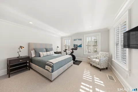 a spacious bedroom with a bed and a window