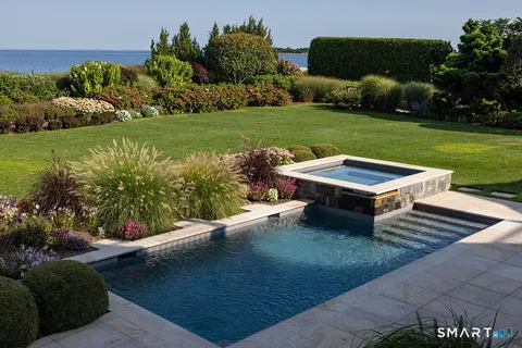 a view of a backyard with plants garden and outdoor seating