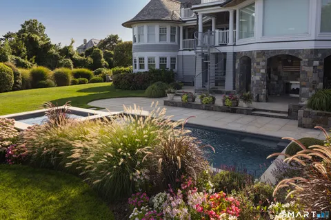 a view of a house with yard and sitting area
