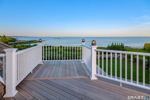 a balcony with wooden floor and fence