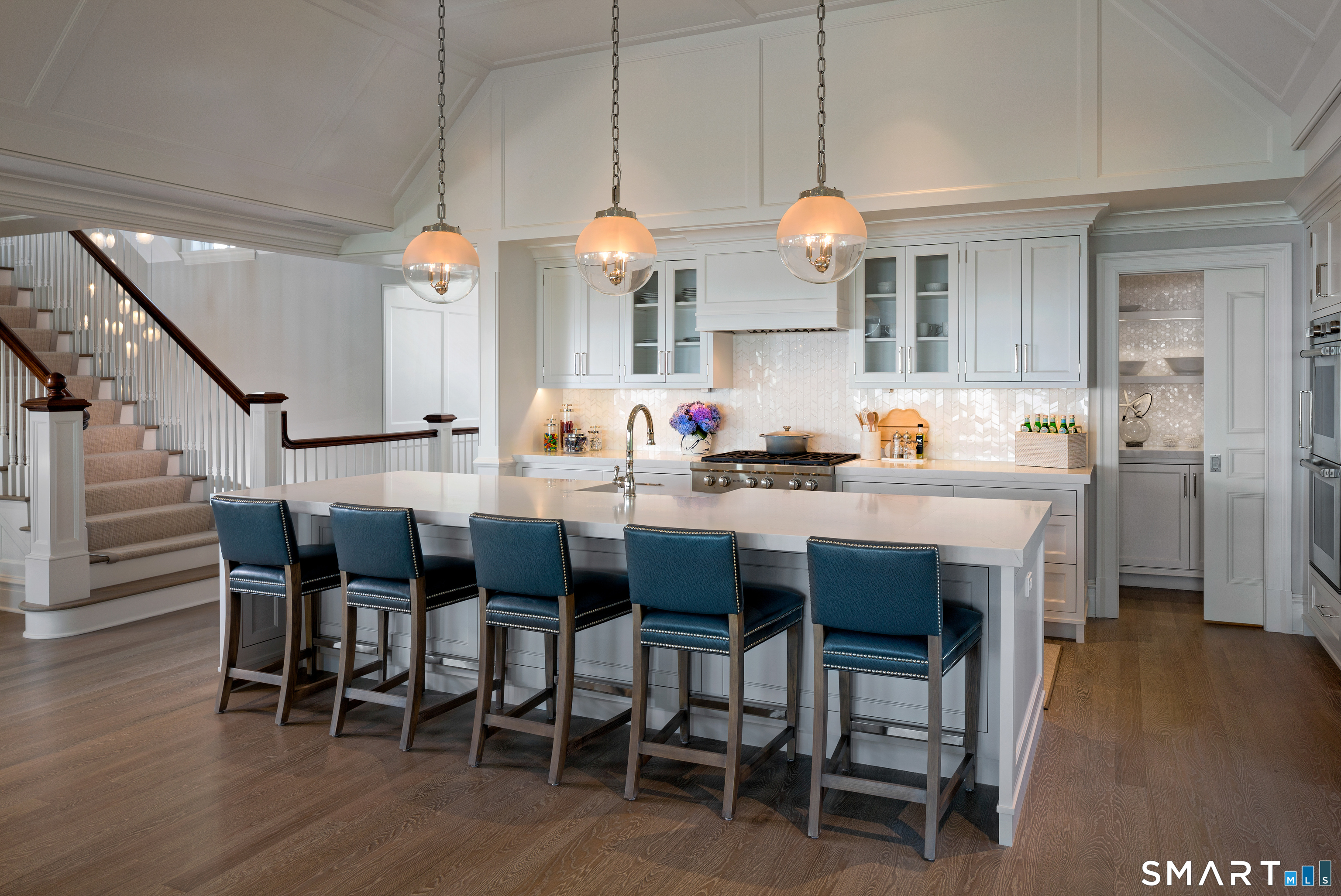 7 Sandpiper Road Westport, CT 06880 - Photo 10 of 34 a dining room with wooden floor a chandelier a wooden table and chairs