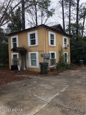 a view of a house with a yard and sitting area