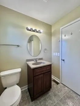 a bathroom with a toilet a sink and a mirror