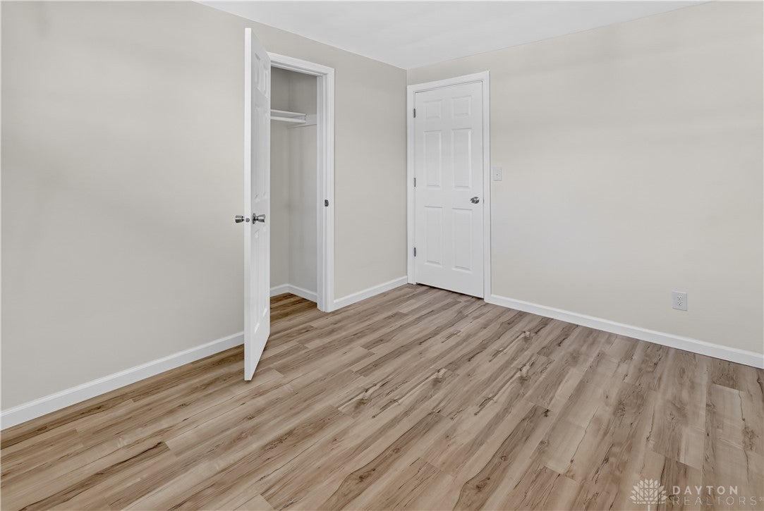 1243 Student Avenue Springfield, OH 45503 - Photo 21 of 38 Smooth wood-look flooring and clean plaster walls define this versatile secondary bedroom space.