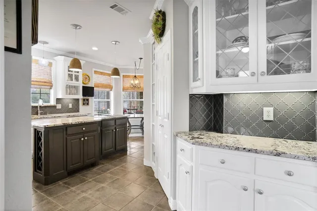 a large bathroom with a granite countertop double vanity and a mirror