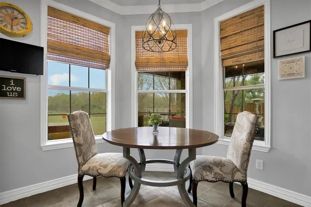 a dining room with furniture a chandelier and wooden floor