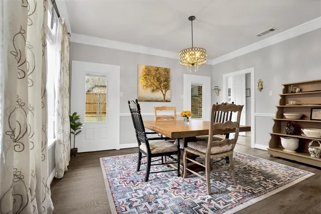 a view of a dining room with furniture wooden floor and a chandelier