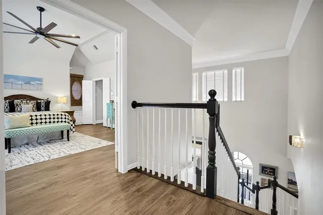 a view of a hallway with wooden floor and a livingroom