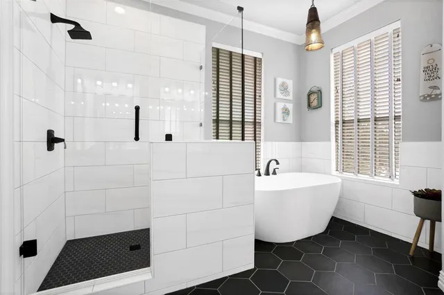 a bathroom with a bathtub and shower