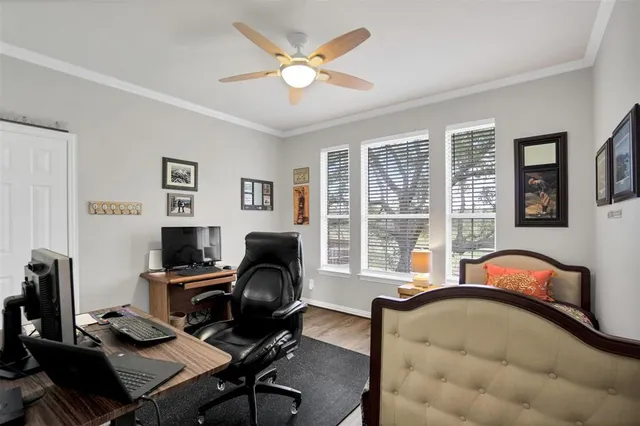 a view of a workspace with furniture and a window