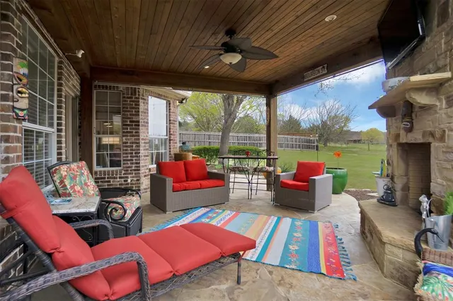 a view of a patio with couches chairs dining table and chairs with wooden floor