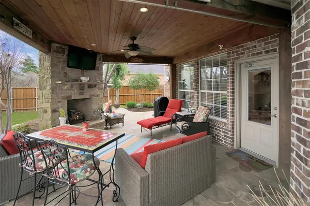 a view of a patio with a table and chairs