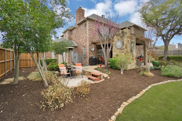 a view of a building with garden and sitting area