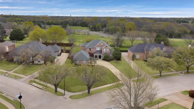 an aerial view of a house with a lake view