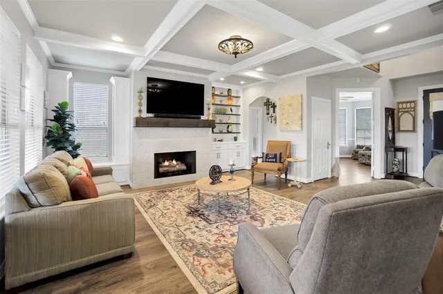 a living room with fireplace furniture and a flat screen tv