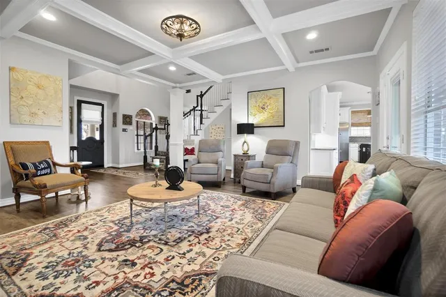 a living room with furniture a rug and a window