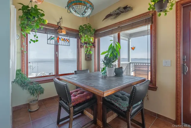 a living room with furniture a large window and appliances