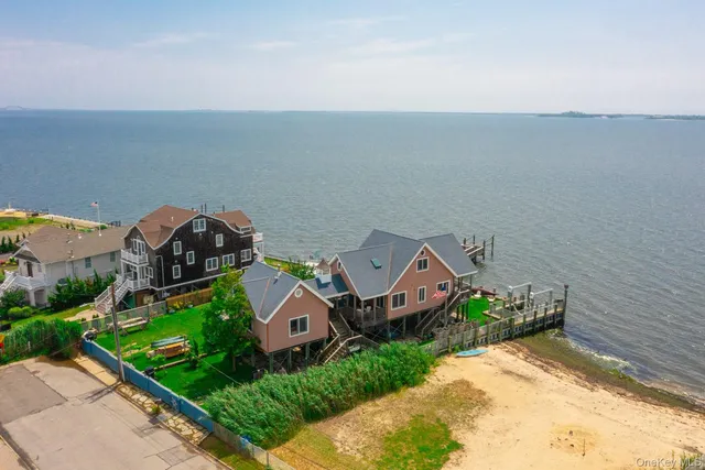 a bedroom with a bed and a potted plant