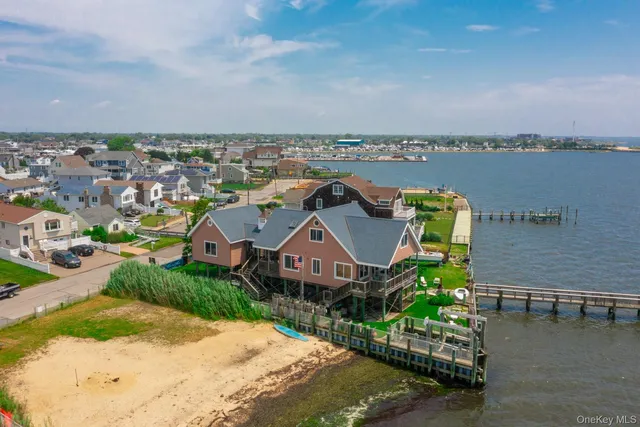an aerial view of a house with a garden and mountain view