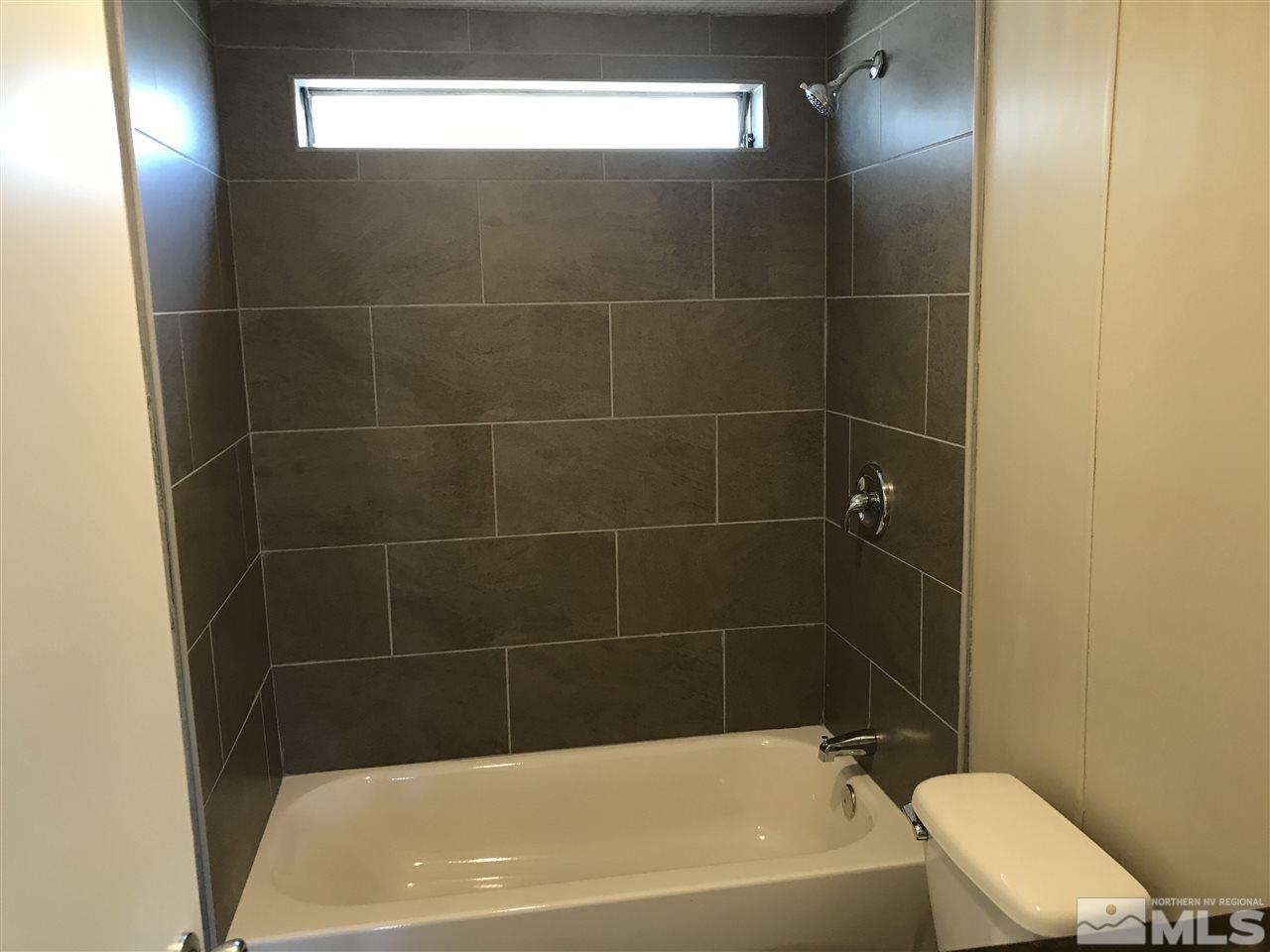 3985 Goldfinch Drive Reno, NV 89508 - Photo 11 of 15 a bath tub sitting next to a white toilet