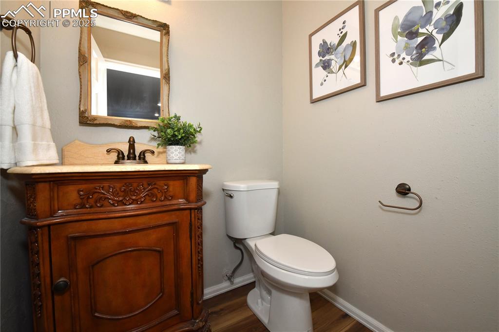 1275 Berglind Road Colorado Springs, CO 80920 - Photo 14 of 30 a bathroom with a toilet a sink and mirror