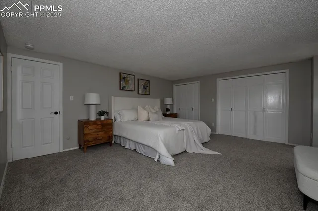 an empty room with floor to ceiling windows and wooden floor