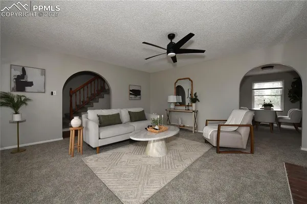 a living room with furniture and white walls