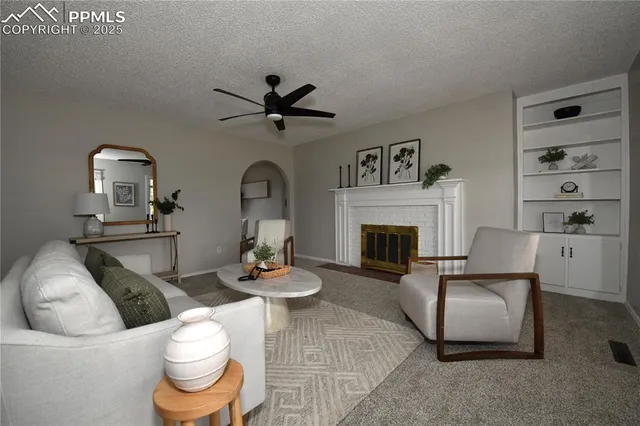 a living room with furniture a rug and a fireplace