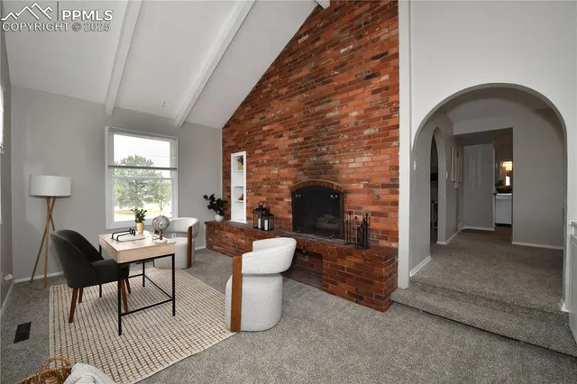 a kitchen with granite countertop a refrigerator and wooden cabinets