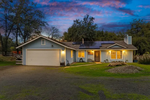 a view of a house with a yard and garage
