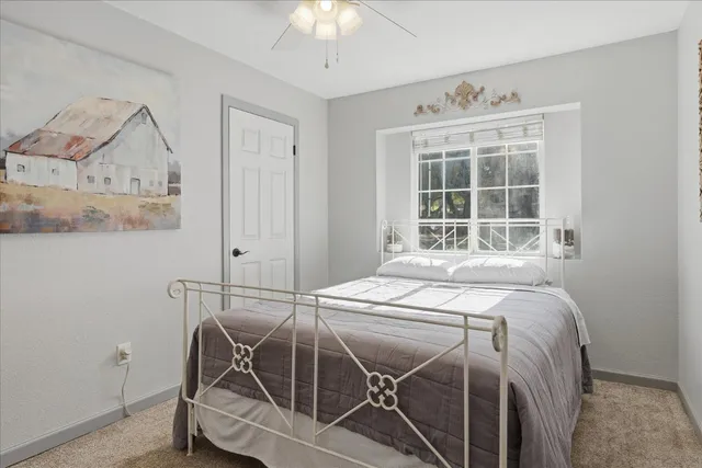 a bed sitting in a bedroom next to a window