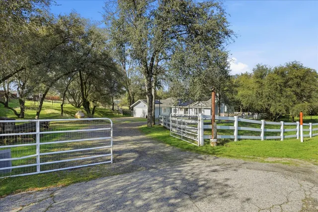 a view of a park with wooden fence