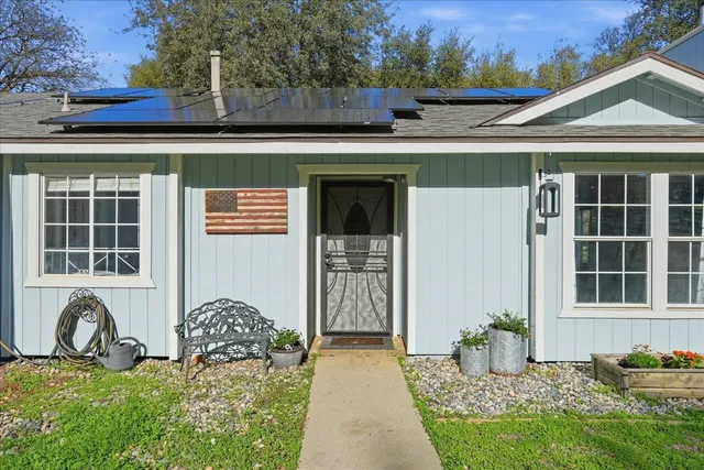 a front view of a house with garden
