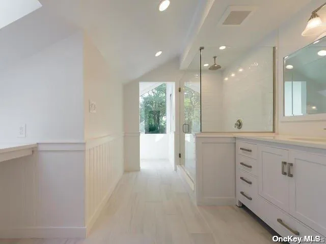 a bathroom with a granite countertop sink mirror and a shower