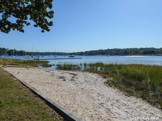 a view of a green field with trees in the background