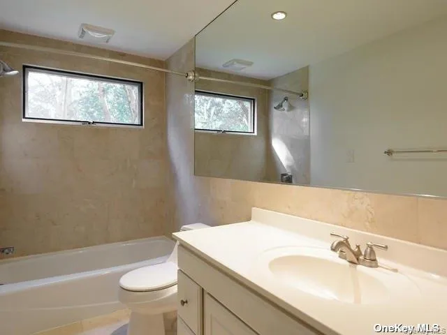 a bathroom with a sink a toilet and tub