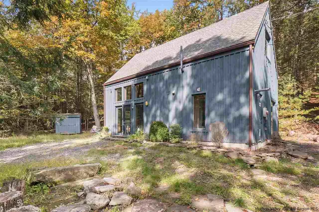 a view of a house with large trees